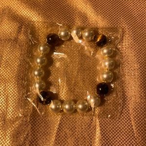 Bracelet pearl look with brown beads. New in package